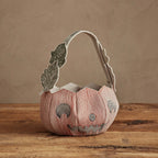 Coral & Tusk felt Jack-o’-Lantern trick-or-treat bucket with embroidered smiling pumpkin face, orange stitching, vine-style strap, and caterpillar, ladybug, and leaf details.
