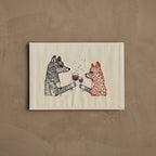 Coral & Tusk Raise a Glass Card, embroidered card featuring a fox and wolf toasting with champagne glasses, with metallic thread bubble details.