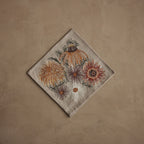 Coral & Tusk Autumn Blossoms embroidered linen 20 × 20-inch folded dinner napkin featuring richly detailed chrysanthemums, African daisies, black-eyed Susans, and sunflowers in vibrant autumn colors.