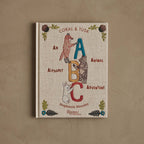 Book titled 'Coral & Tusk: An Alphabet Animal Adventure' by Stephanie Housley on a brown background.