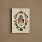 Coral & Tusk embroidered Baby Bluebird Card featuring a baby bluebird framed in a garland of greenery and flowers, with tiny bluebirds, baby chicks, and a little lamb, stitched on cotton fabric and sewn to paper.