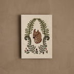 Coral & Tusk embroidered Fawn in Ferns Card featuring a young fawn in a meadow of ferns with small wildflowers in purple and rust-colored threads, stitched on cotton fabric and sewn to paper.